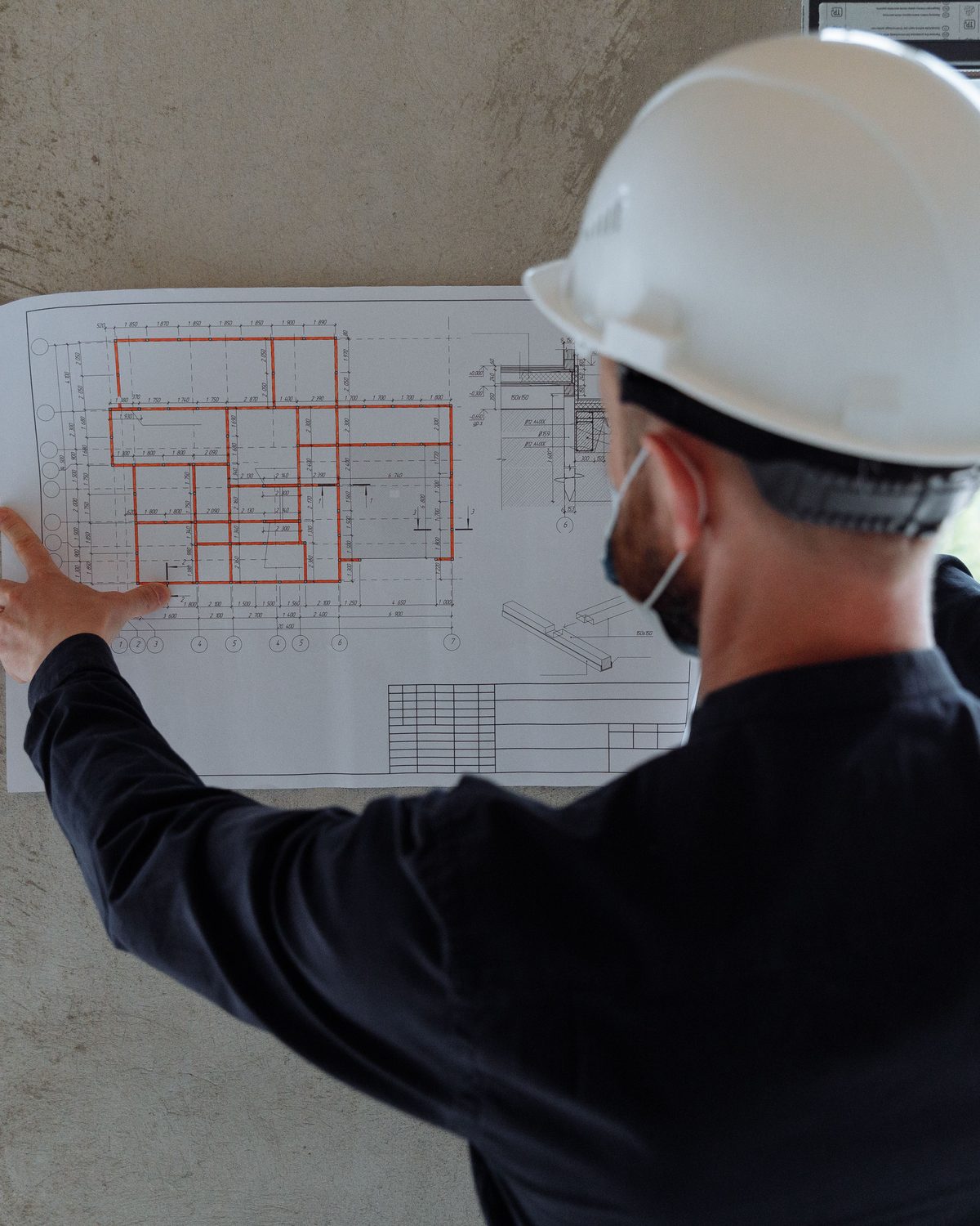 ASME engineer reviewing low-current layout drawings on site