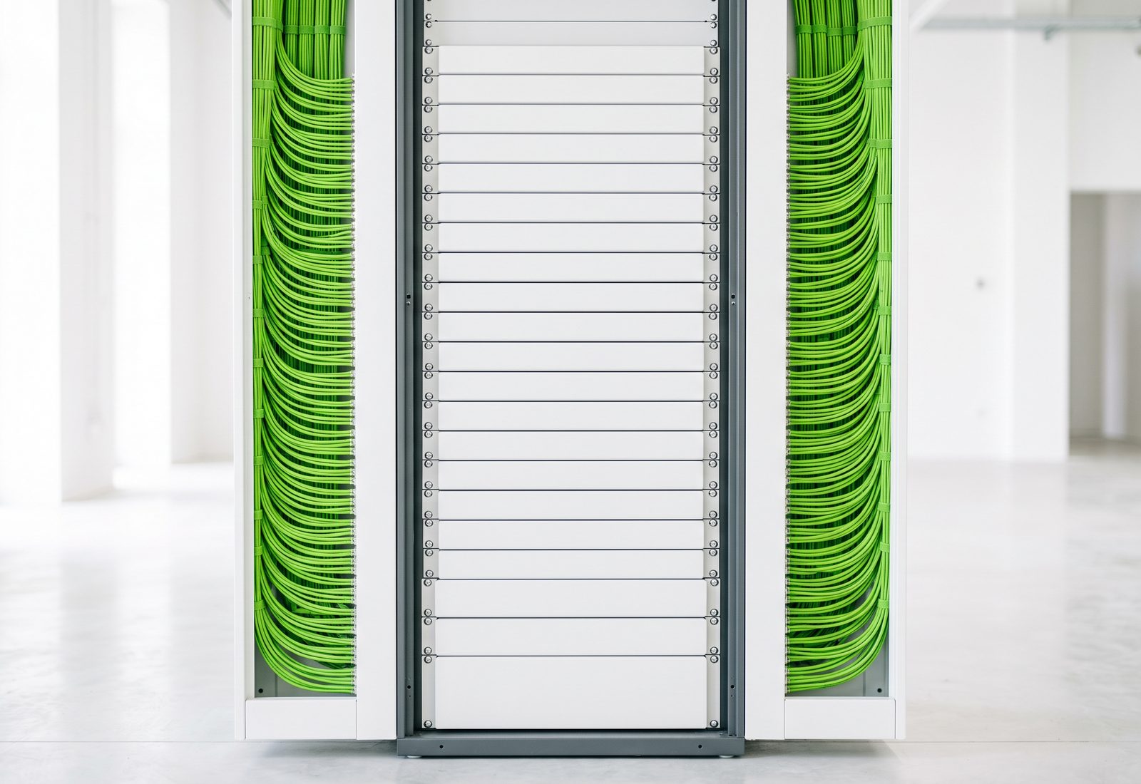 Structured cabling bundles dressed down both sides of a communications rack