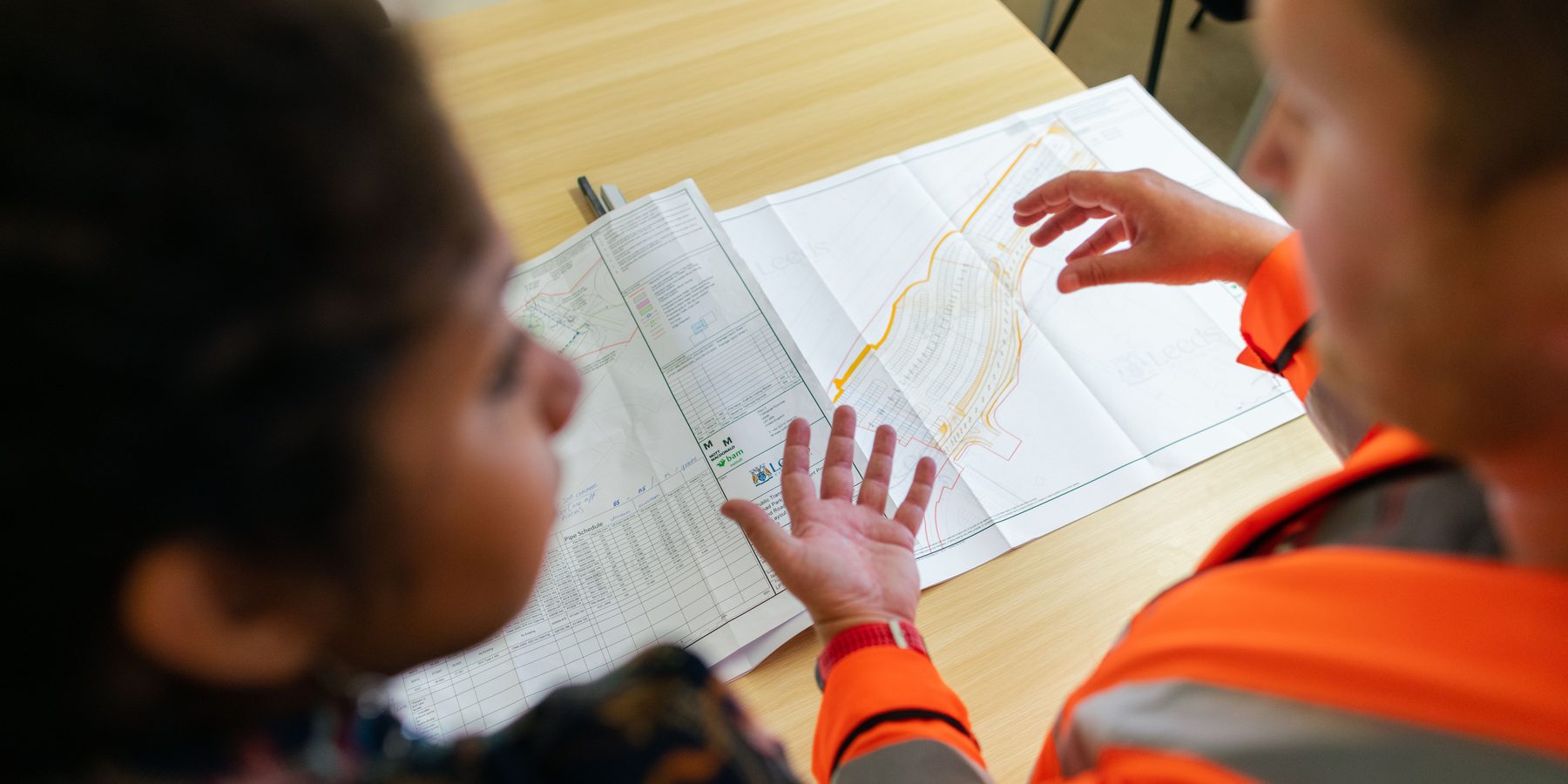 ASME engineers coordinating over project drawings